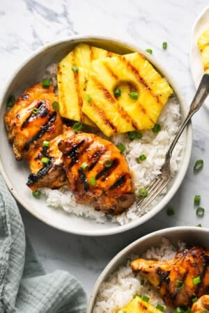 hawaiian huli huli chicken with rice and pineapple on platter